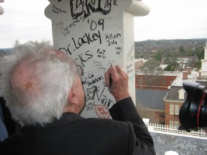 At Mercer University's 175th Anniversary in 2008, Ferrol Sams signs the Mercer tower.