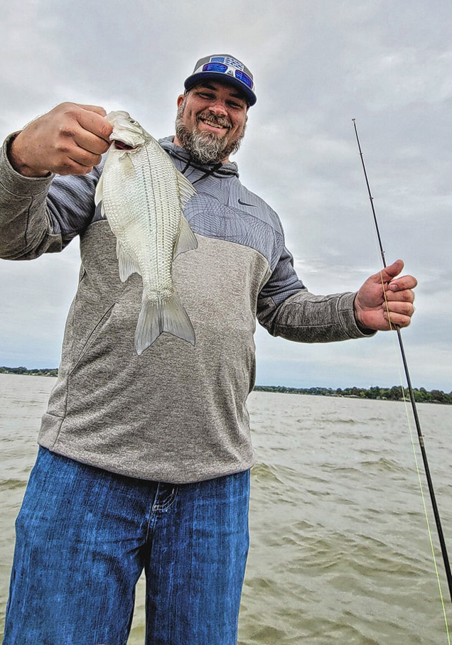 Lyle Wallace holds a sand bass