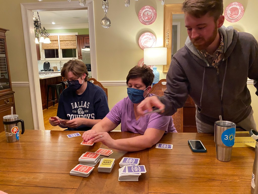 Harris, Carla and Barron Wallace playing a card game called "Just Like Mama Used to Say."