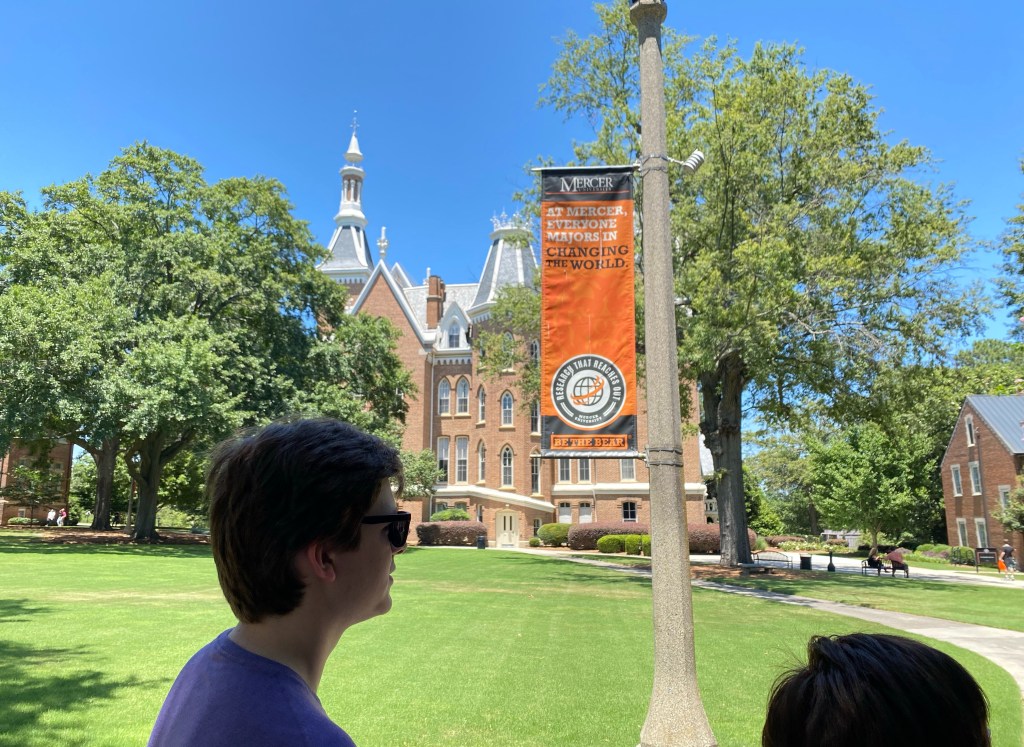 Harris Wallace listens to a tour guide outside of the R. Kirby Godsey Administration Building on the historic quad of Mercer University's campus.