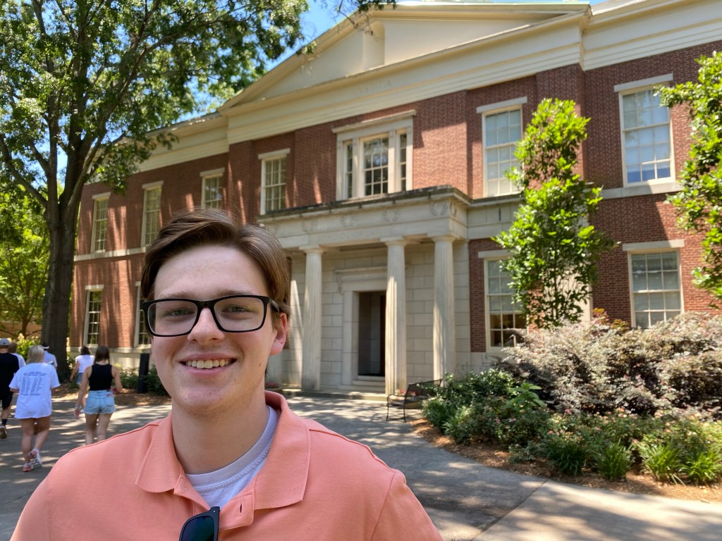 Harris Wallace poses in front of the University of Georgia School of Law.