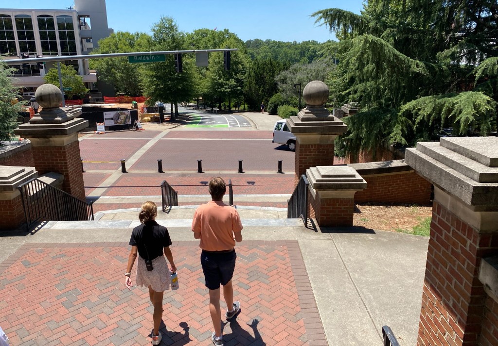 Harris Wallace talks with a female UGA tour guide on the Million Dollar Staircase on the campus of the University of Georgia in Athens.