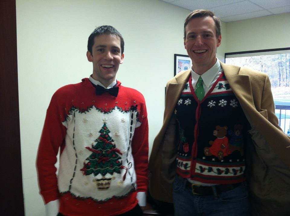 Brian Greer and Lance Wallace stand in Lance's office at the Cooperative Baptist Fellowship wearing tacky Christmas sweaters.