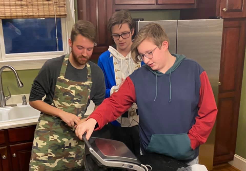 Barron, Harris and Carlton Wallace check out Barron's new sandwich press in the kitchen.