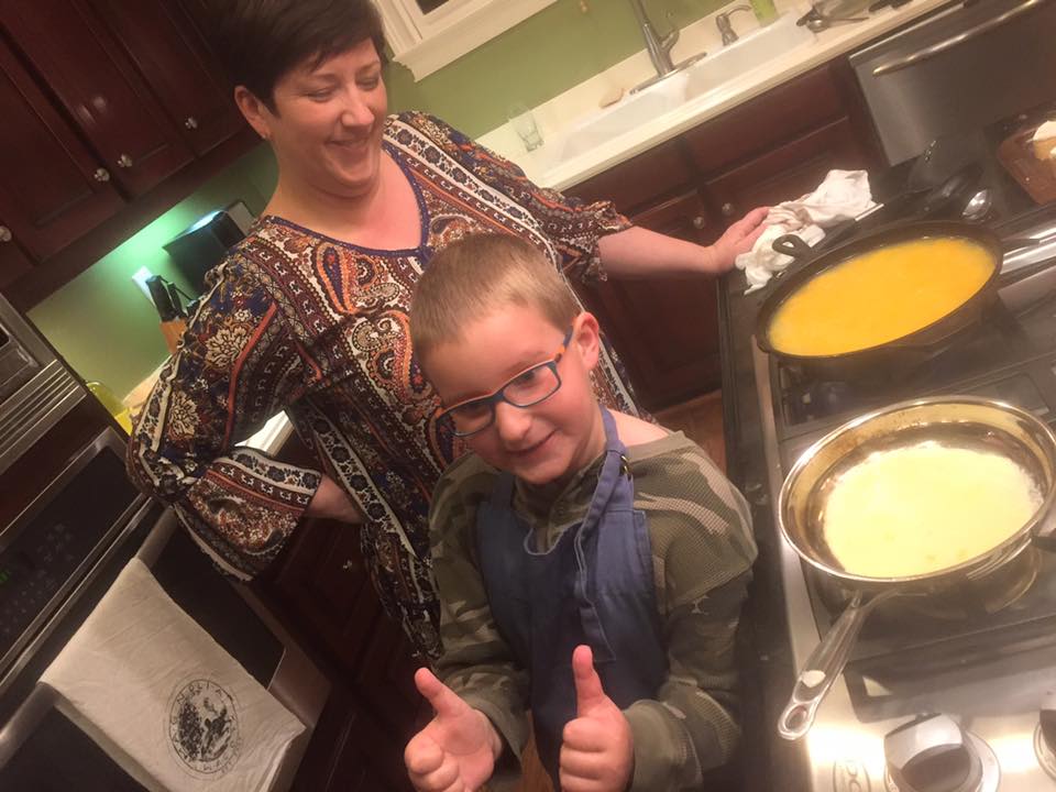Carla and Carlton in the kitchen with two skillets on the stovetop making crepes and eggs.