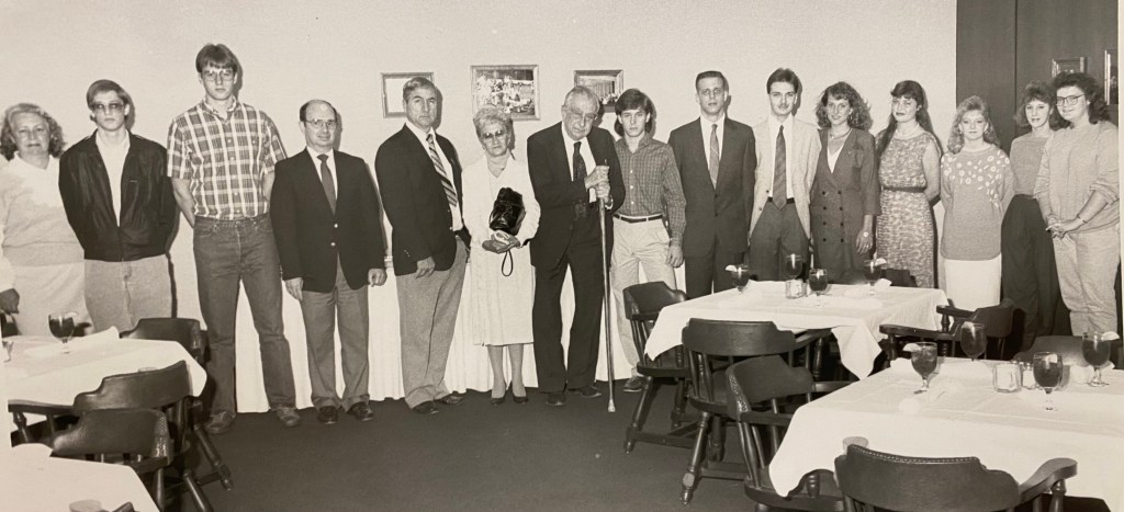 A group of college students with Edward Teller in university dining room