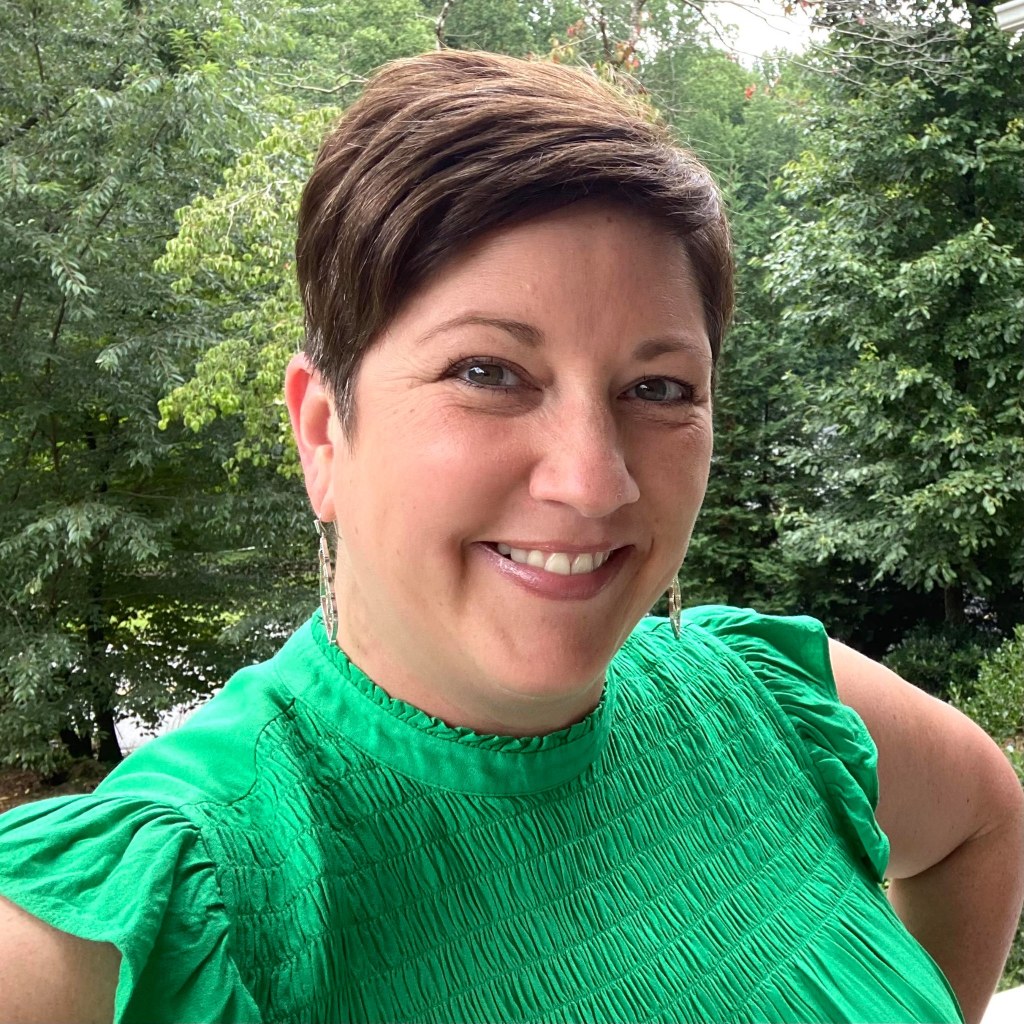 Carla Barron Wallace with trees in the background