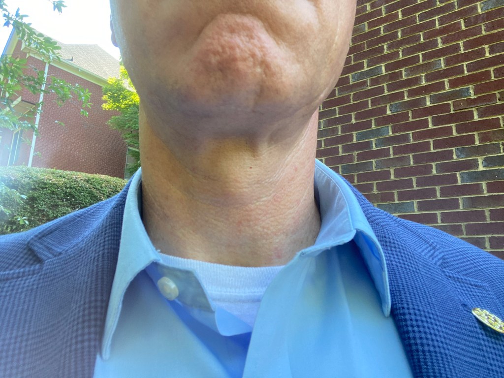 man in open collar with sports coat