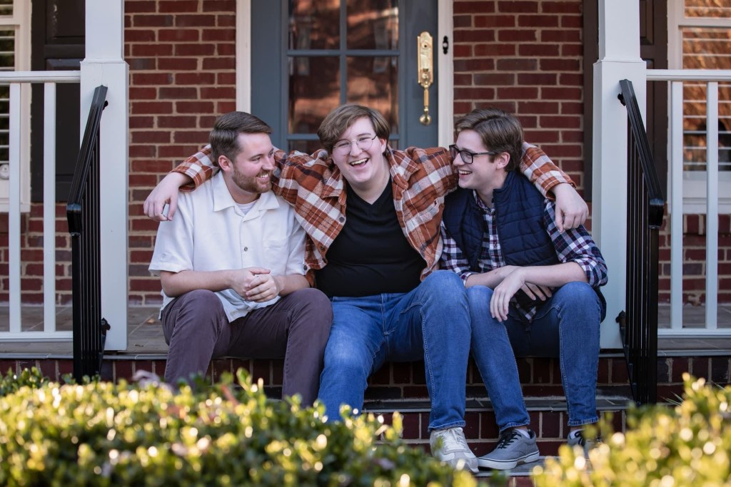 Three young men on a front porch