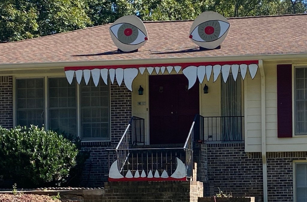 Front door of a home with giant teeth and eyes