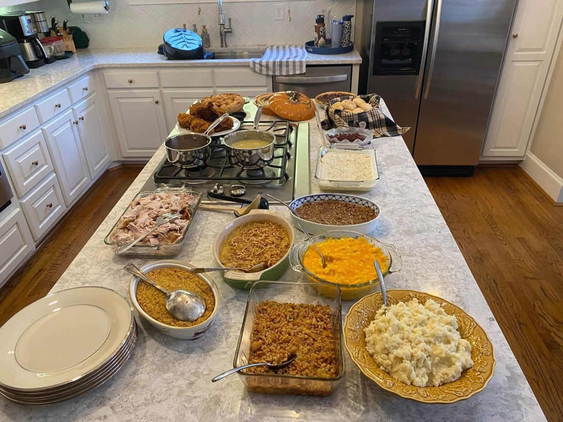 Countertop filled with Thanksgiving meal dishes.