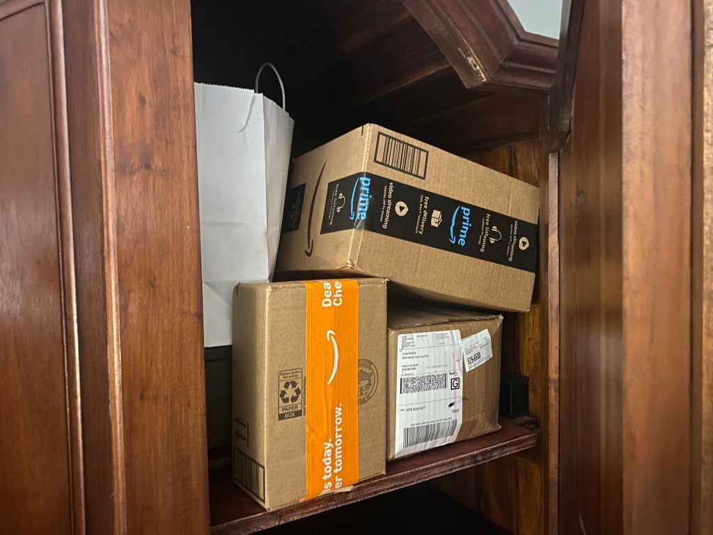 Amazon packages in a wooden cabinet