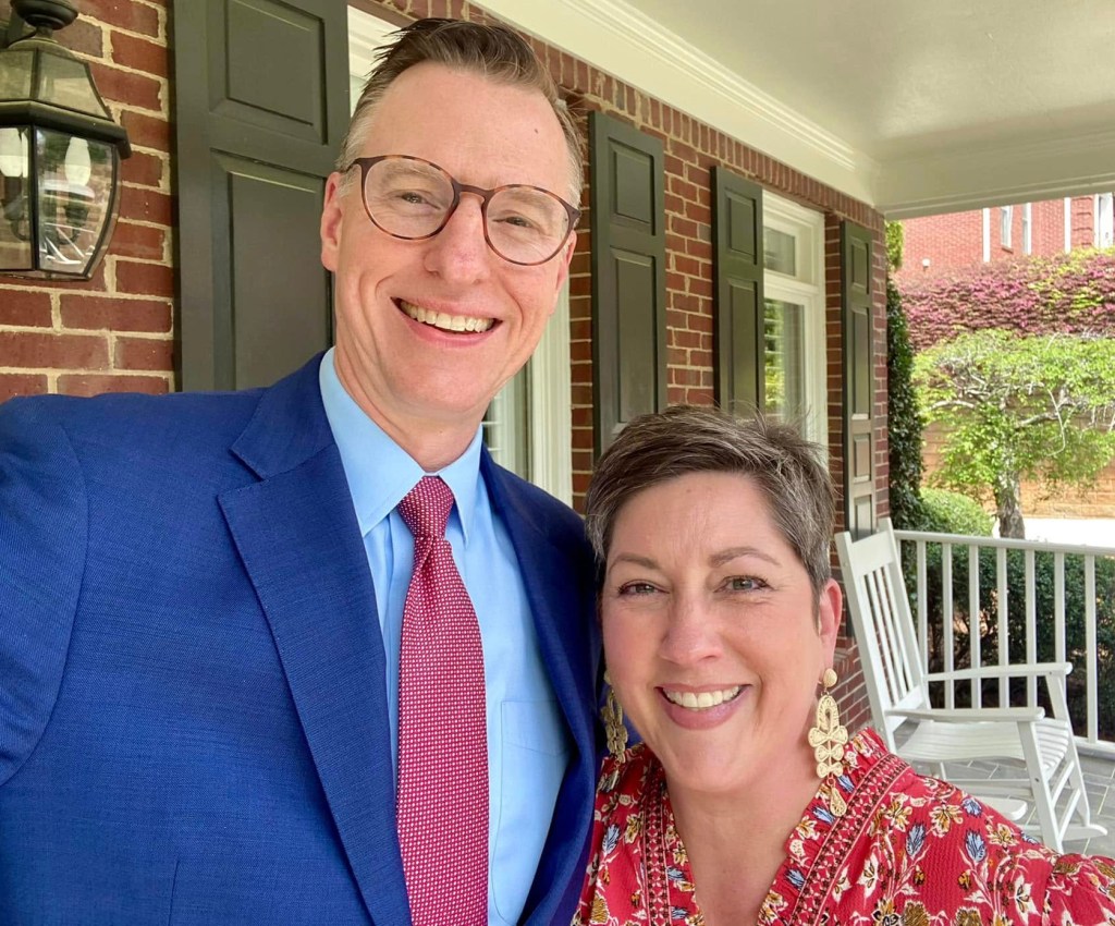 A married couple on their front porch