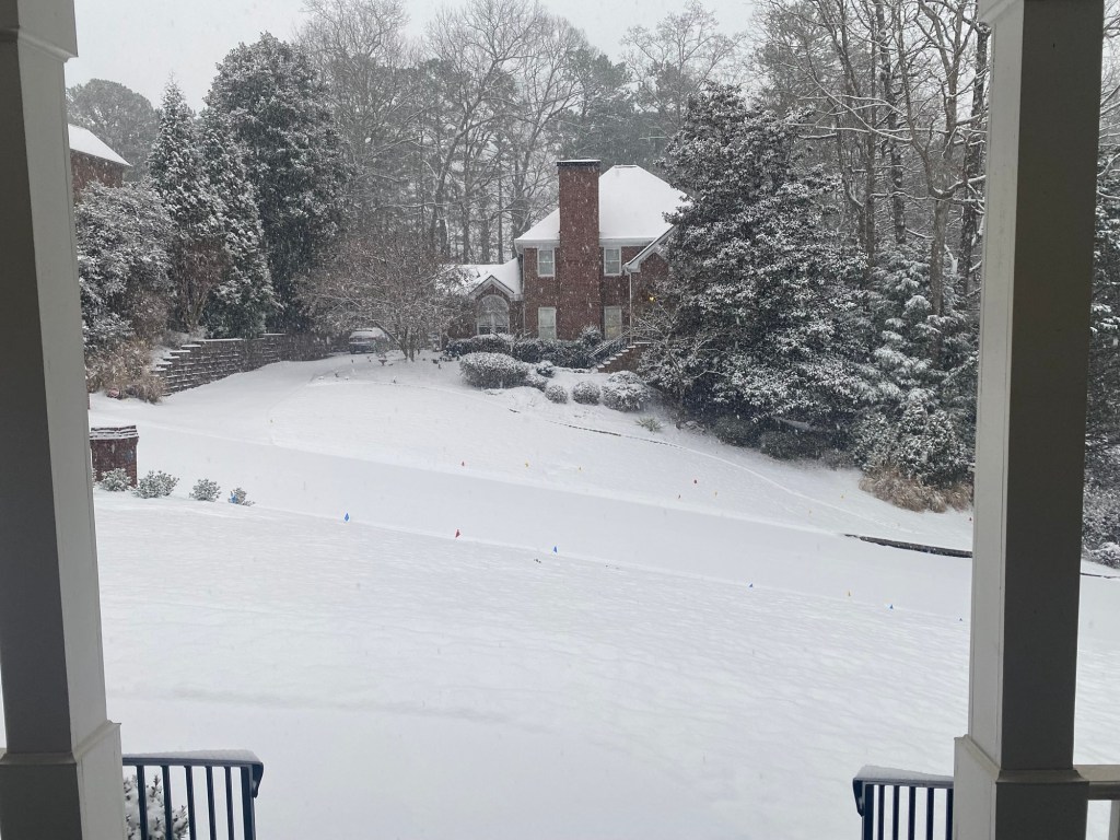 front yard completely covered in snow.