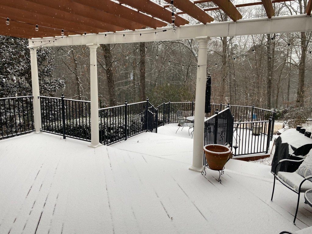 A back deck and pergola coated in snow