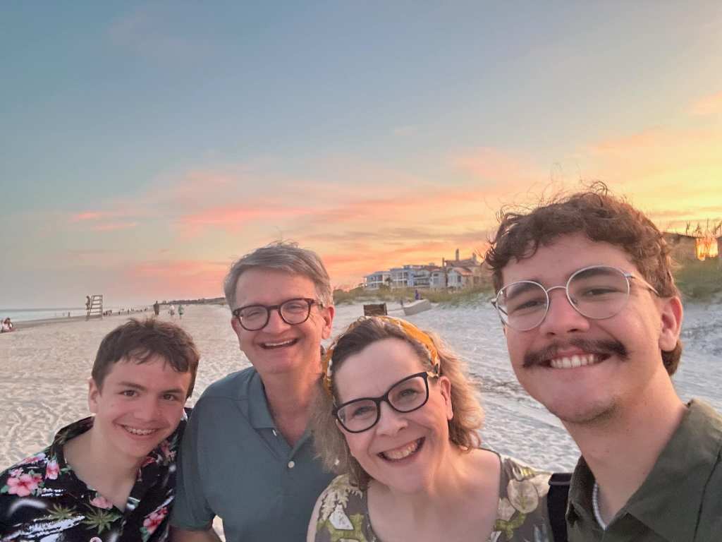 A family on the beach at sunset
