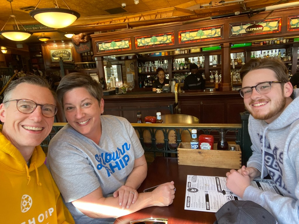 Two men and a woman at a restaurant table