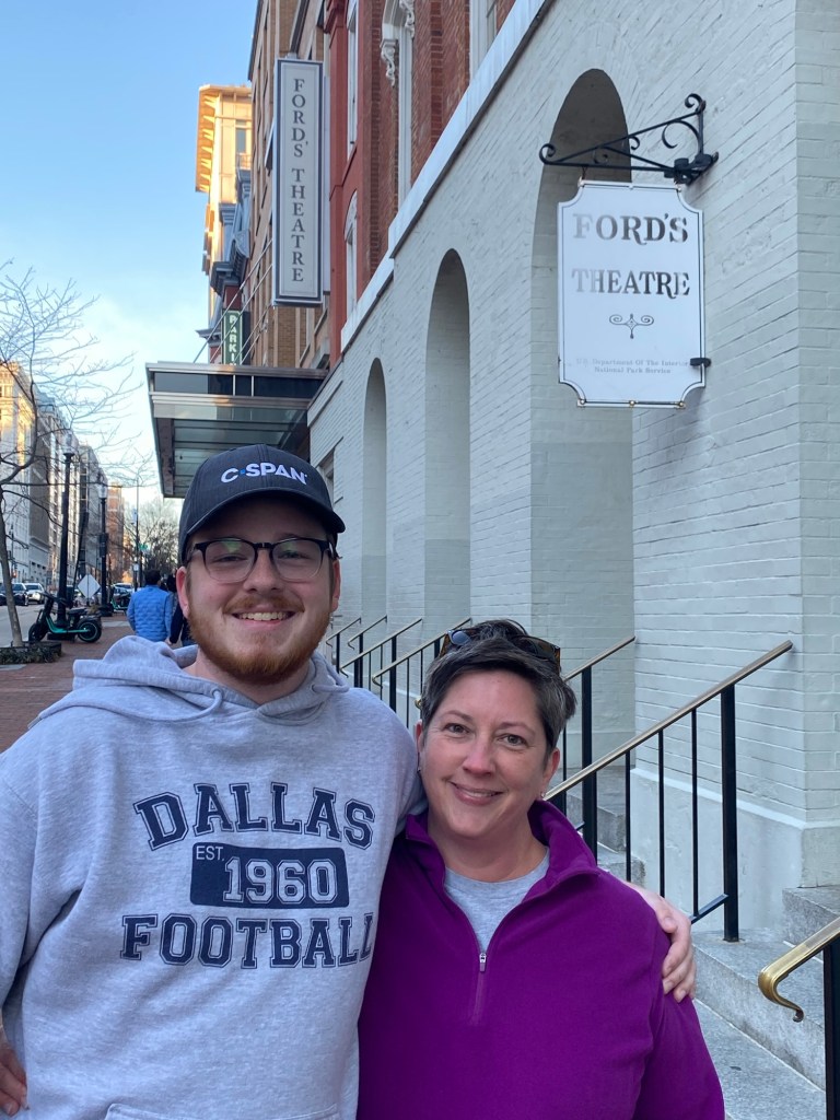 A young man and woman stand outside Ford's Theatre