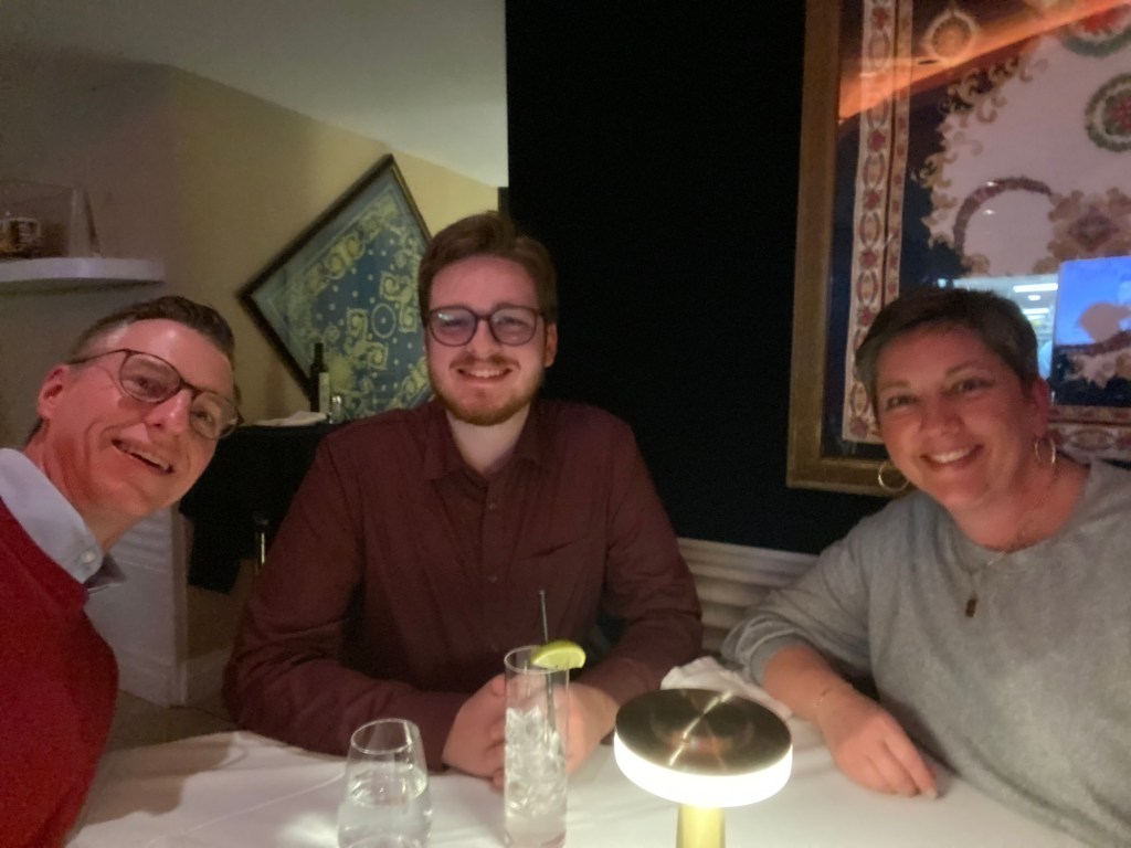 Two men and a woman at Cafe Milano