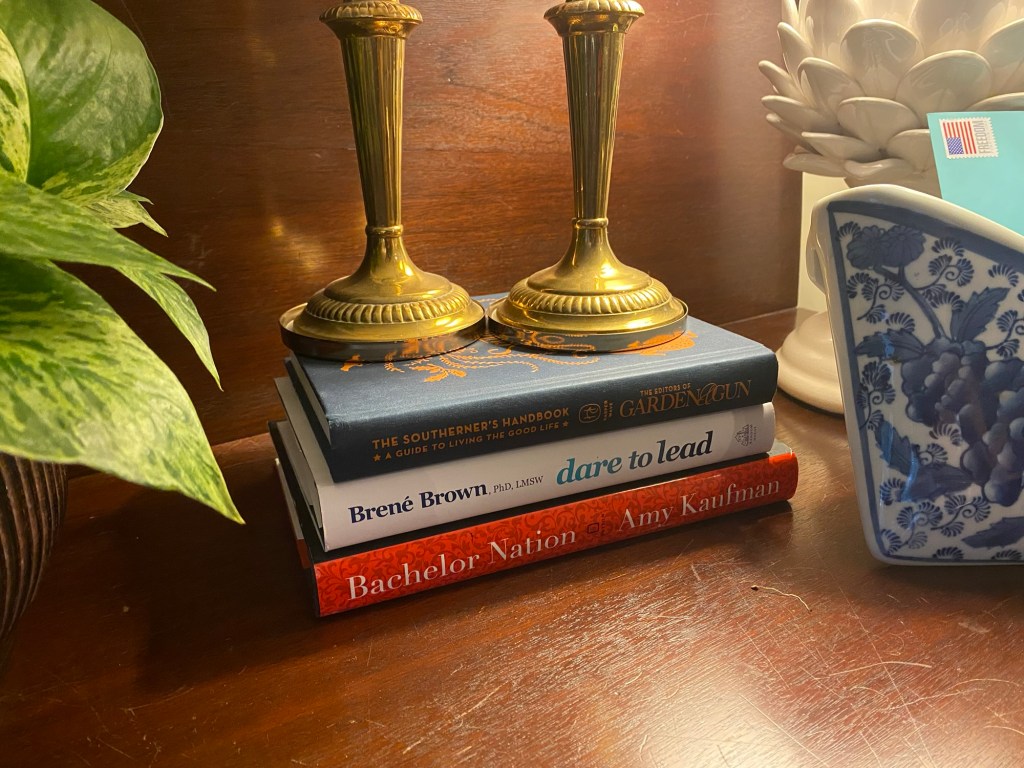 Stack of books holding up candlesticks