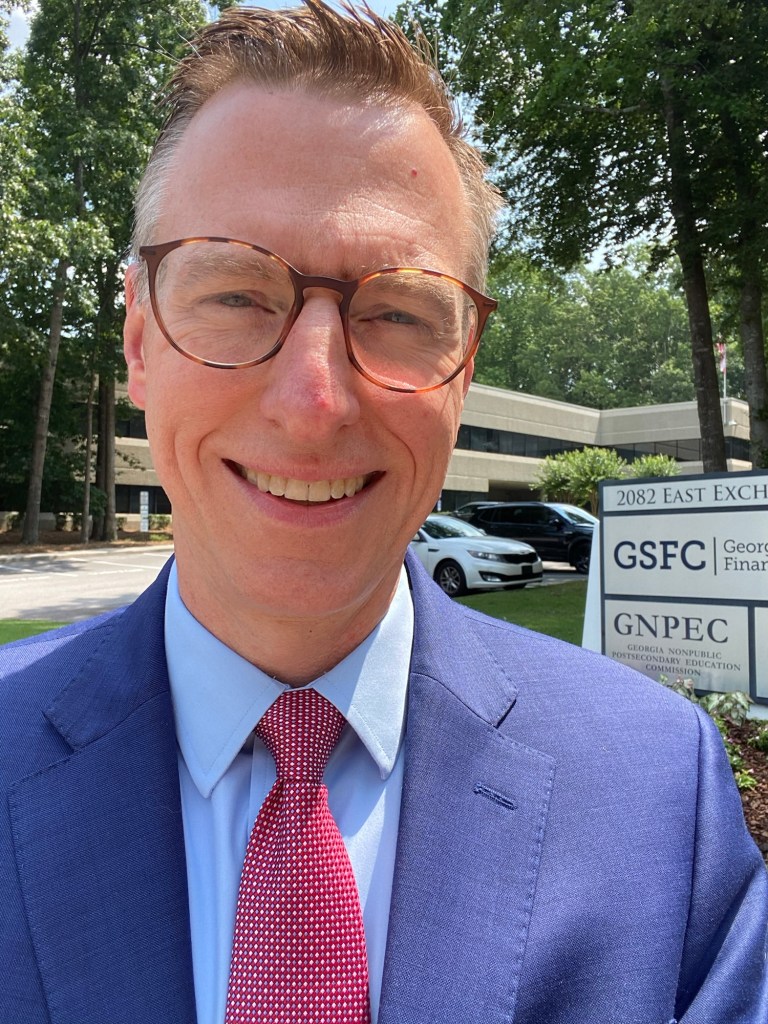 A man in a suit outside of an office building