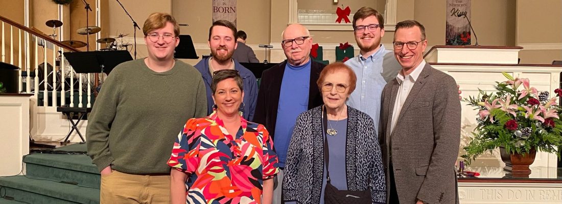 A family standing at the front of a church