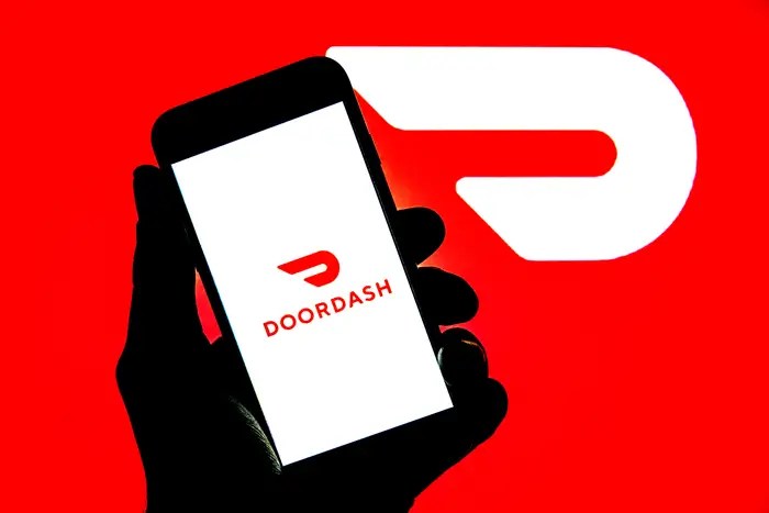hand holding phone with doordash app open