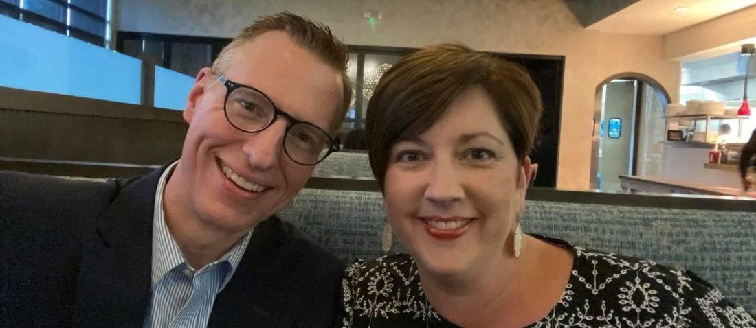 A man and woman in a booth at a restaurant