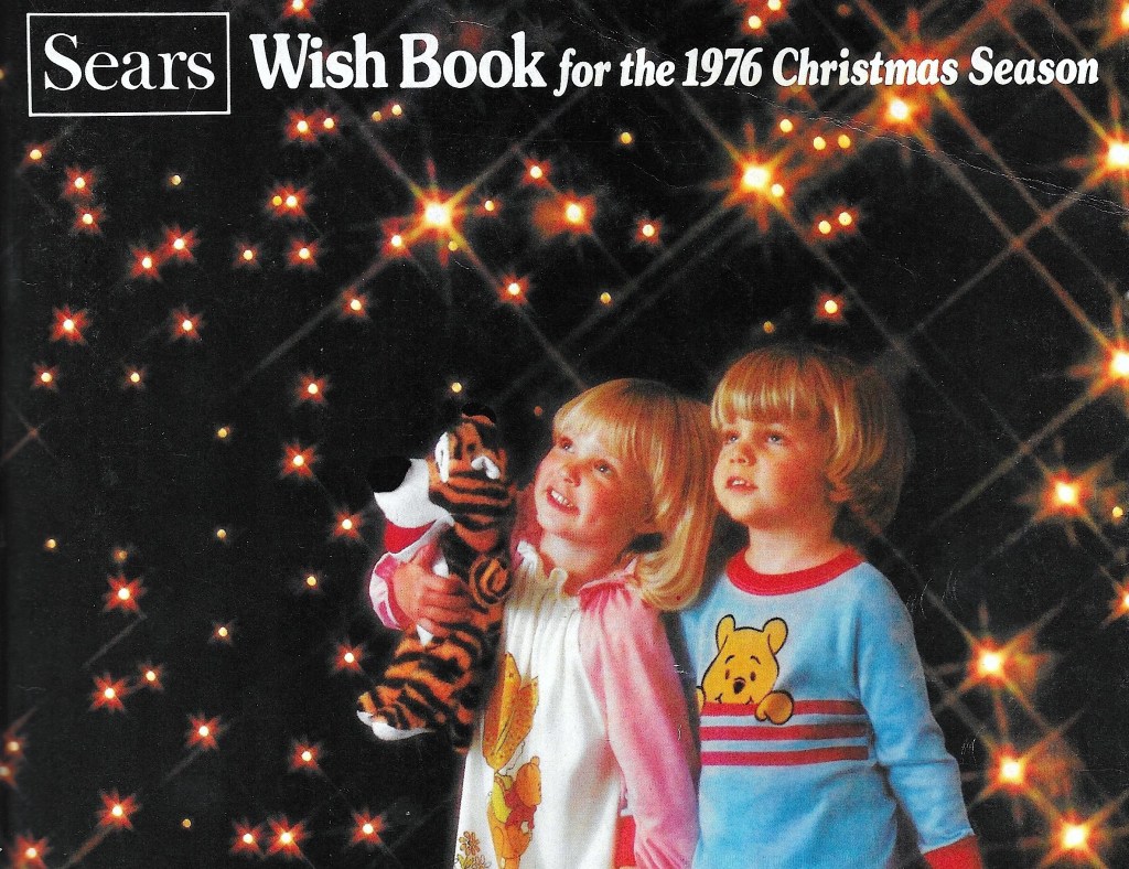 Cover of 1976 Sears Wish Book catalogy with two small children in pajamas in front of a background with sparking lights.