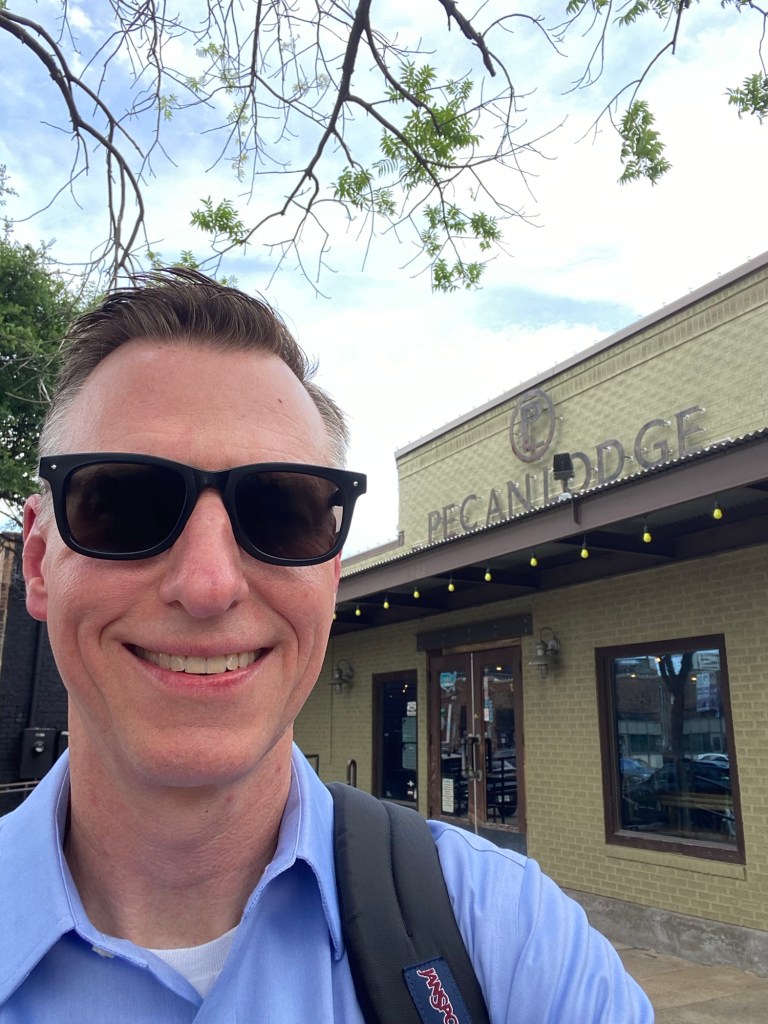 A man in sunglasses outside of the Pecan Lodge restaurant in Dallas