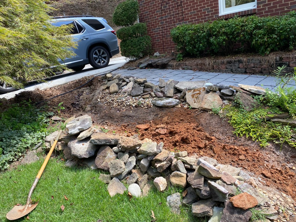 Rocks removed from a stream bed with dirt spread around