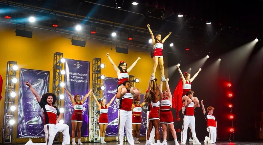 Cheerleaders in a pyramid formation on a stage