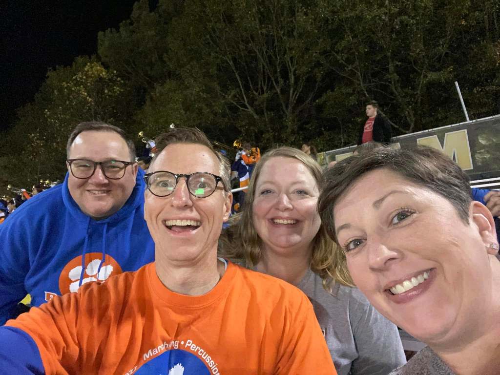 Band parents in the stands at a high school football game