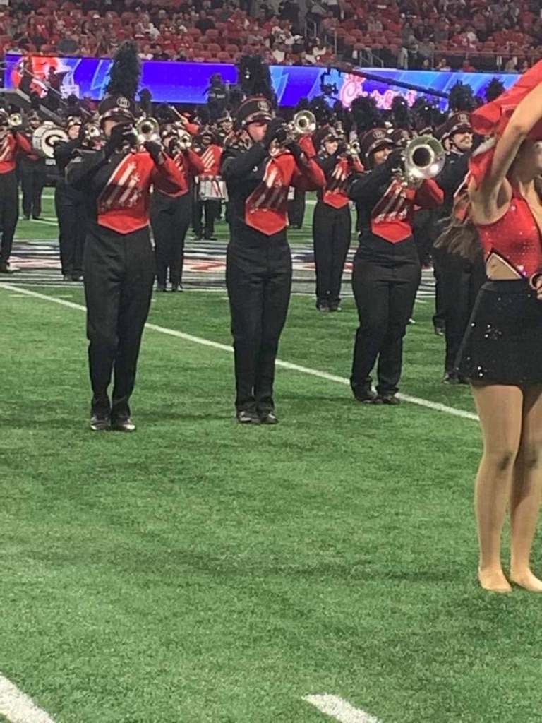 Members of the Redcoat Marching Band on the field at the Peach Bowl