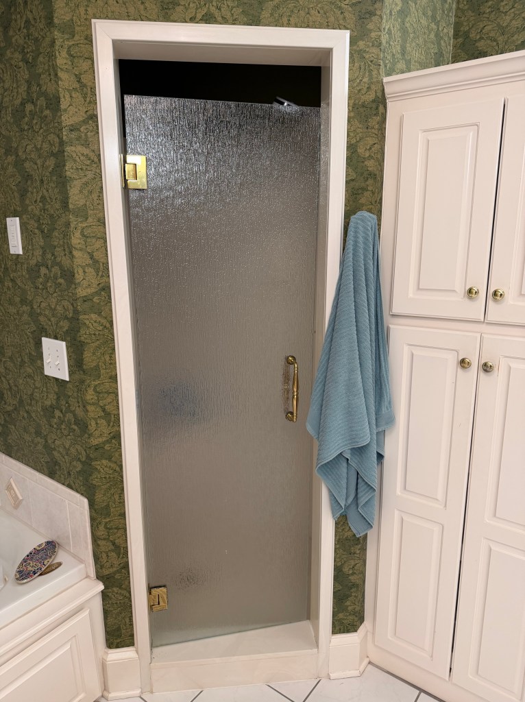 A shower stall with the light off