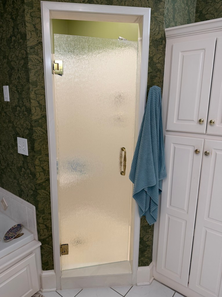 A shower stall with the light on.