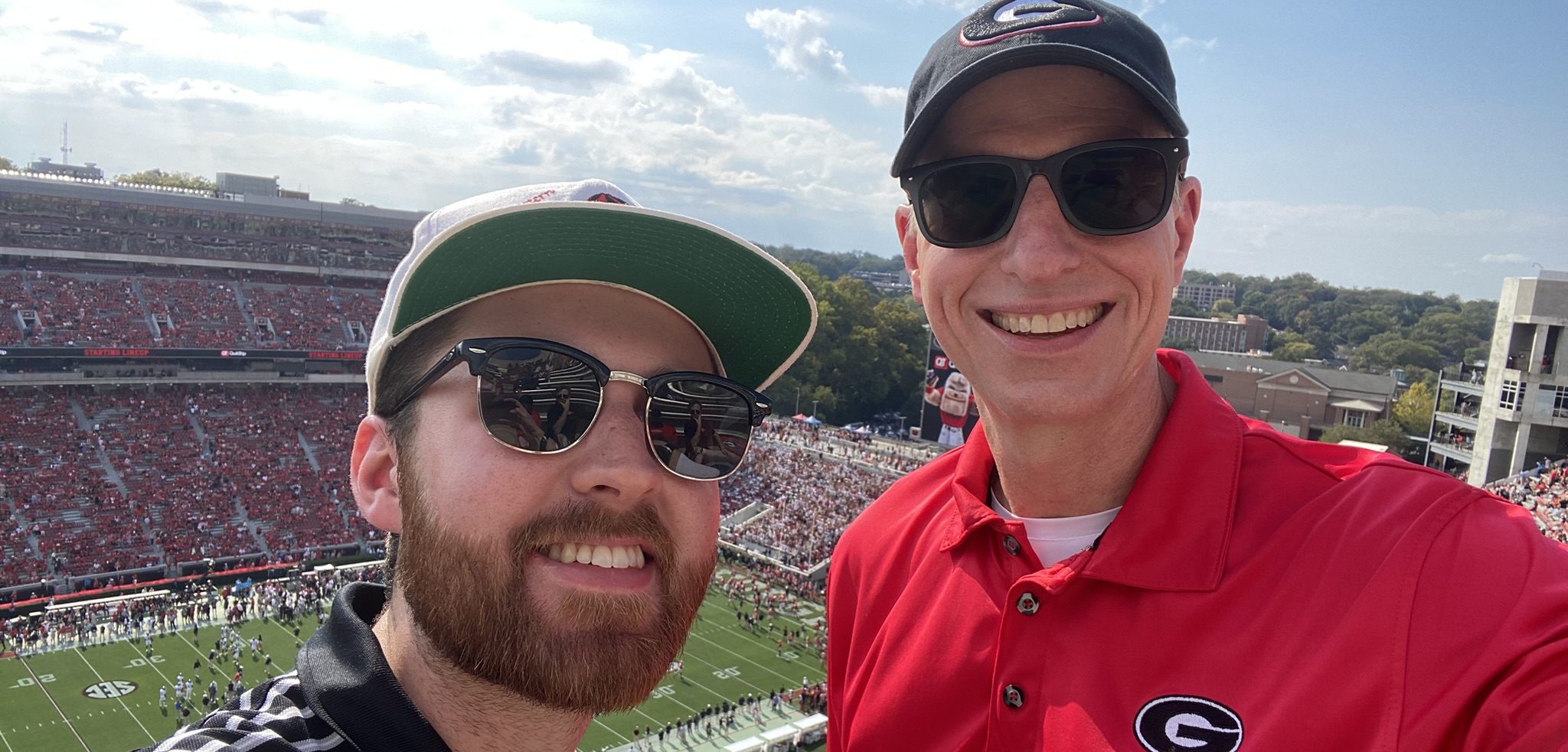 Two men in the upper deck of Sanford Stadium before a game.