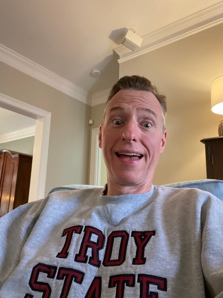 A man in a Troy State sweatshirt