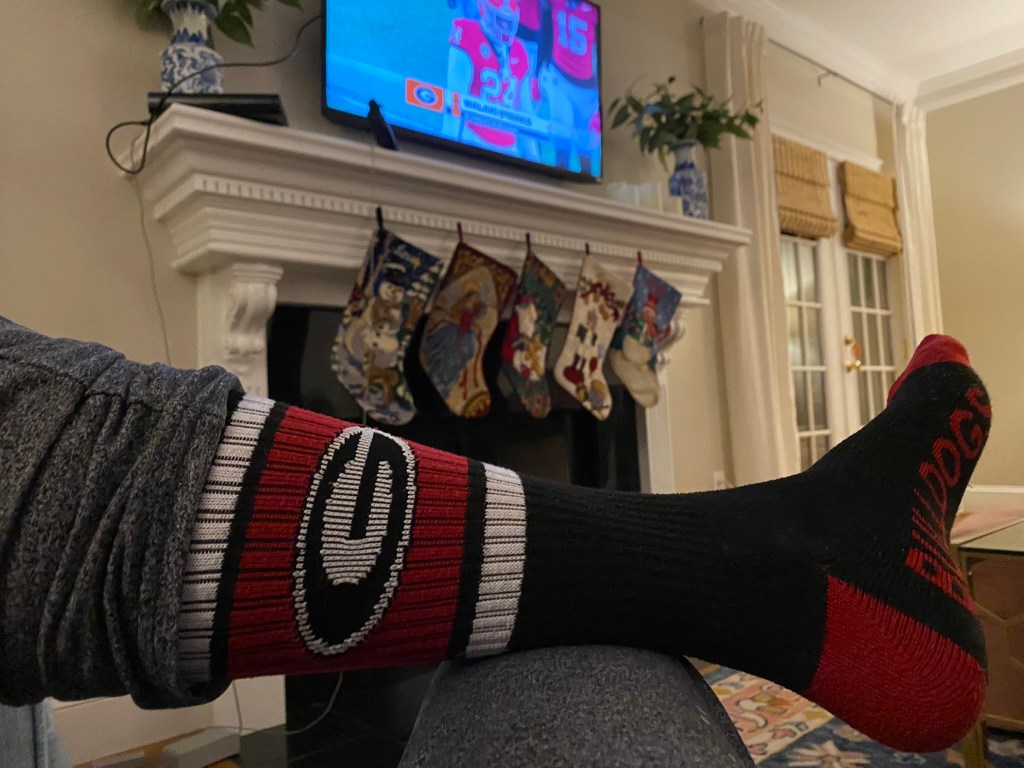 A man's foot adorned with a University of Georgia sock