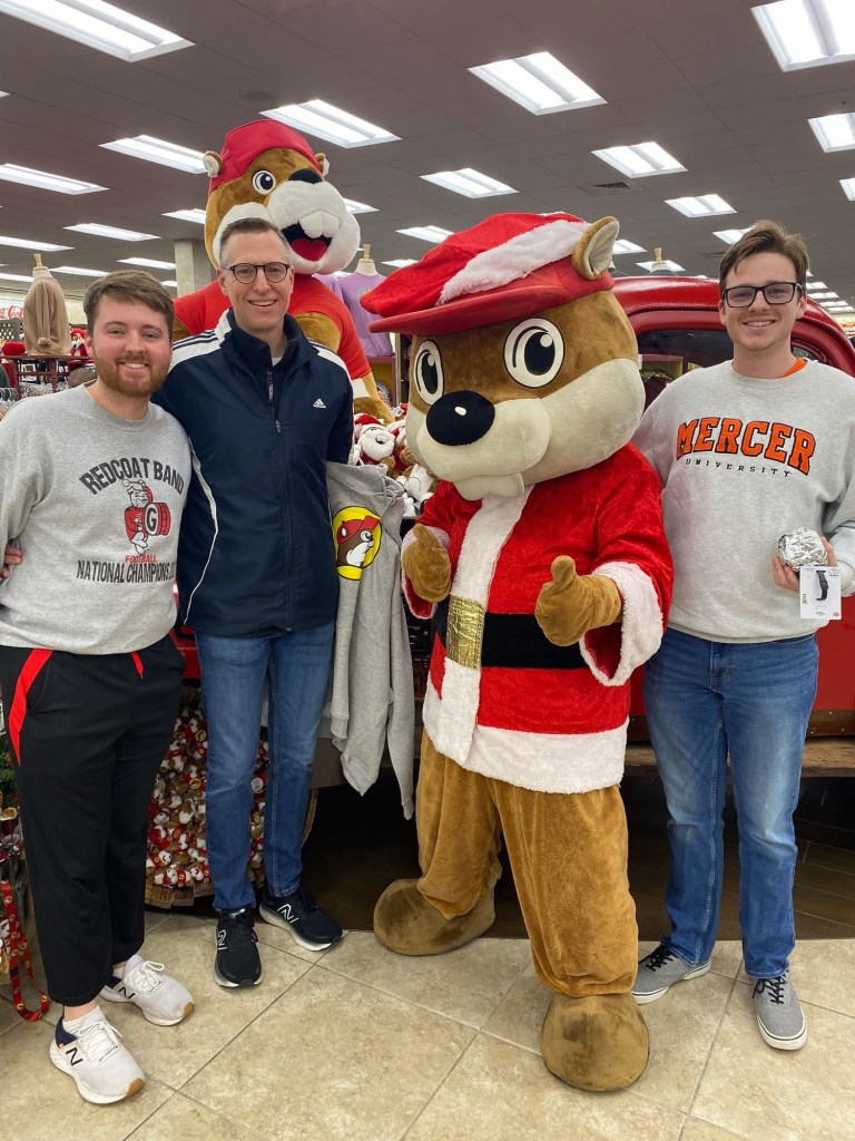 Three men with the Bucee's mascot