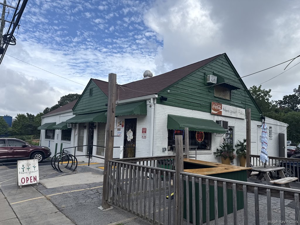 Exterior of a small green and white restaurant